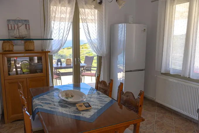 Dining table and dresser by the doors to the sea-view balcony