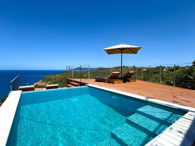 The pool and sun deck overlooking the coast