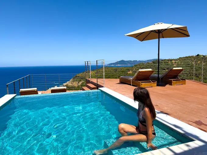 Relaxing on the pool steps with the sea beyond