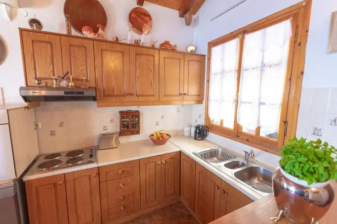 Wooden kitchen with a window and fresh herbs