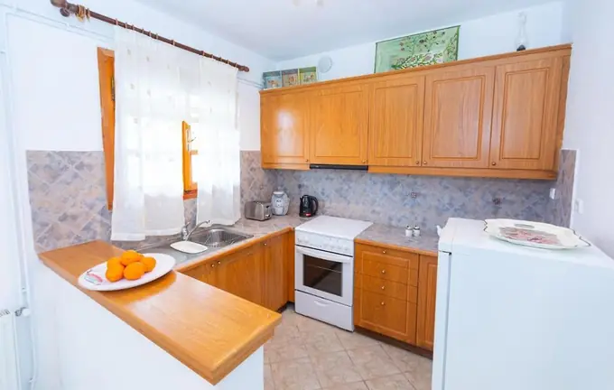 Kitchen with wooden cabinets and an oven