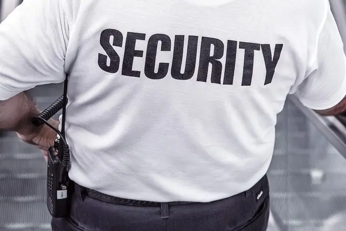 A security officer with a radio